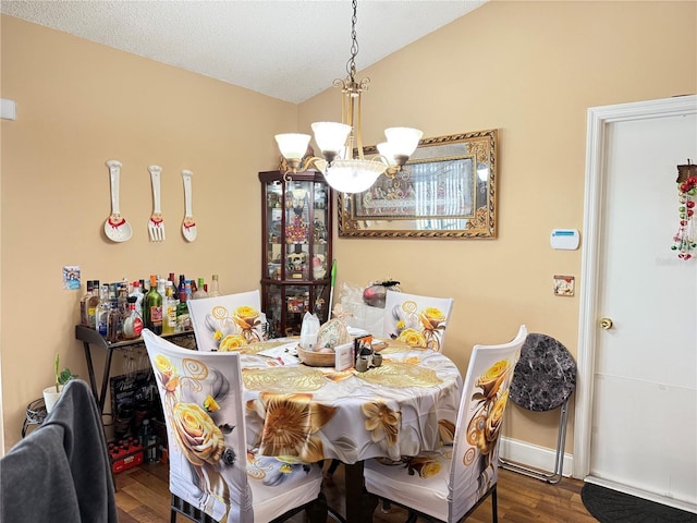 dining space with vaulted ceiling, wood-type flooring, and an inviting chandelier