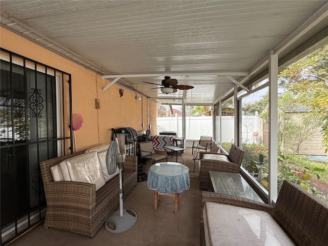 sunroom featuring ceiling fan