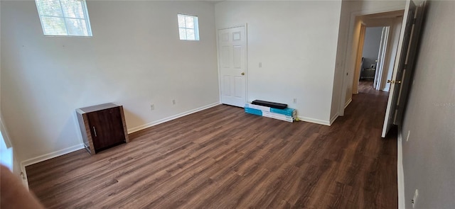 spare room with dark hardwood / wood-style floors