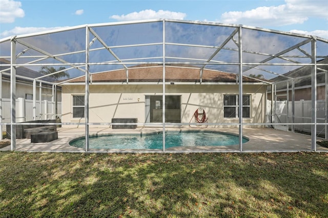 back of house with a patio, a lanai, and a yard