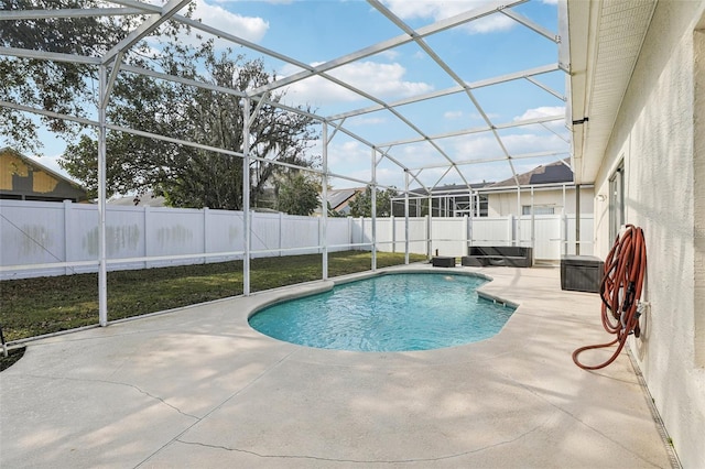 view of pool featuring a patio and glass enclosure