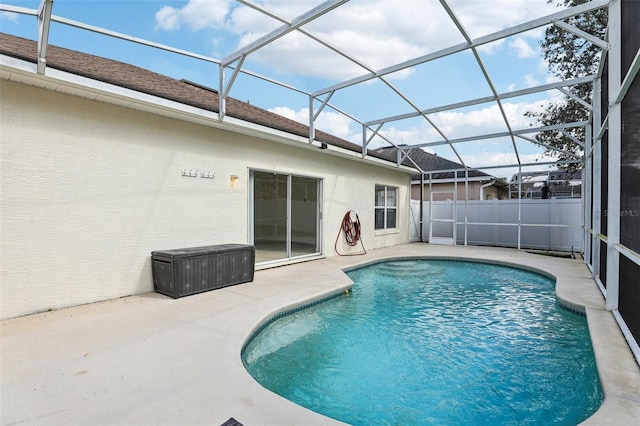 view of swimming pool featuring a lanai and a patio