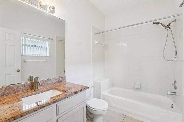 full bathroom featuring vanity, tiled shower / bath combo, tile patterned floors, and toilet