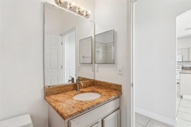 bathroom with vanity, tile patterned floors, and toilet