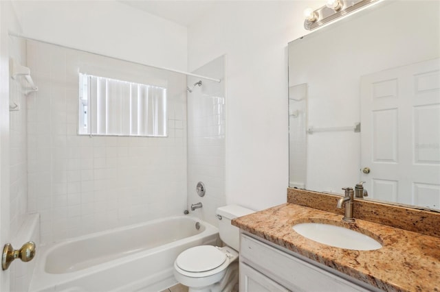 full bathroom with vanity, toilet, and tiled shower / bath