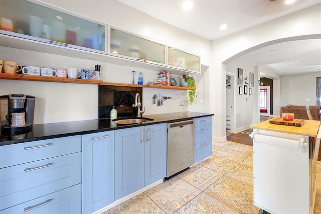 kitchen featuring open shelves, recessed lighting, arched walkways, a sink, and dishwasher