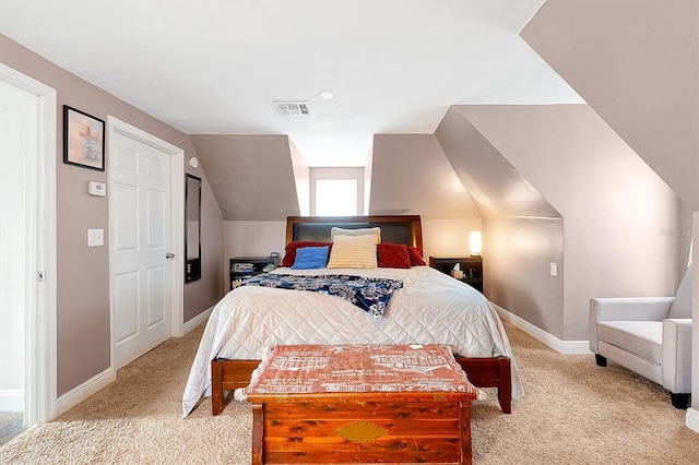 bedroom featuring visible vents, baseboards, light colored carpet, and vaulted ceiling