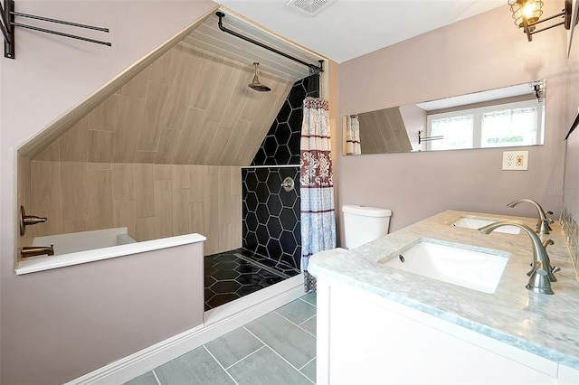 bathroom featuring a tile shower, visible vents, tile patterned floors, and vanity