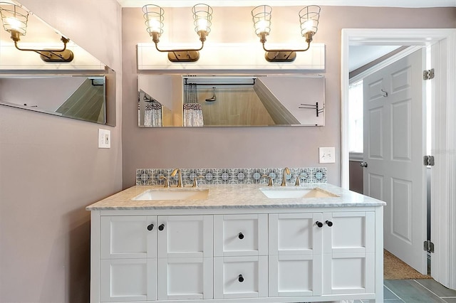 full bathroom with a sink and double vanity