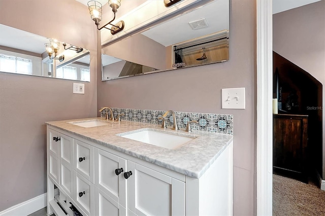 full bathroom with double vanity, visible vents, baseboards, and a sink