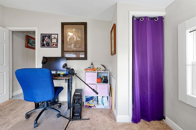 home office featuring lofted ceiling, baseboards, and carpet floors