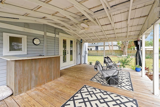 wooden terrace with french doors, a ceiling fan, and fence