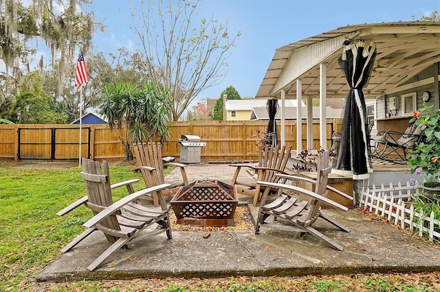 view of yard with a patio, a fenced backyard, and an outdoor fire pit