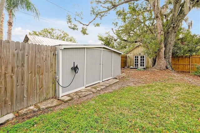 view of shed with a fenced backyard