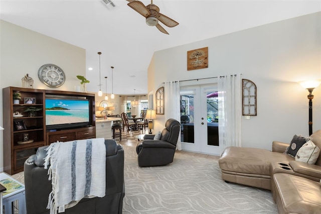 living room featuring lofted ceiling, light colored carpet, ceiling fan, and french doors