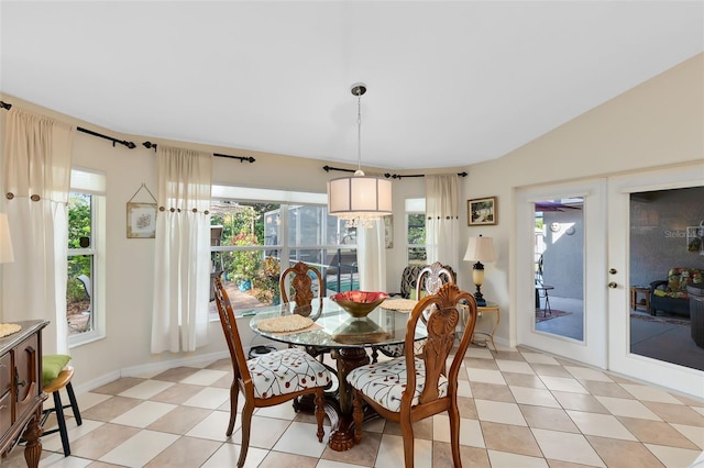 dining room with vaulted ceiling, a wealth of natural light, and french doors