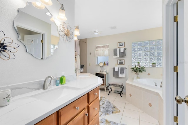 bathroom with vanity, tile patterned floors, tiled bath, and ceiling fan