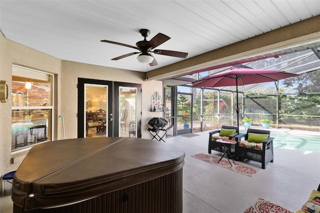 view of patio with a lanai, outdoor lounge area, and ceiling fan