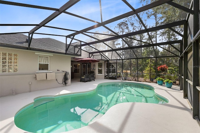 view of pool featuring a patio and glass enclosure