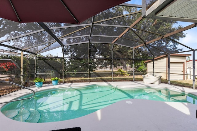 view of pool with a patio area and glass enclosure