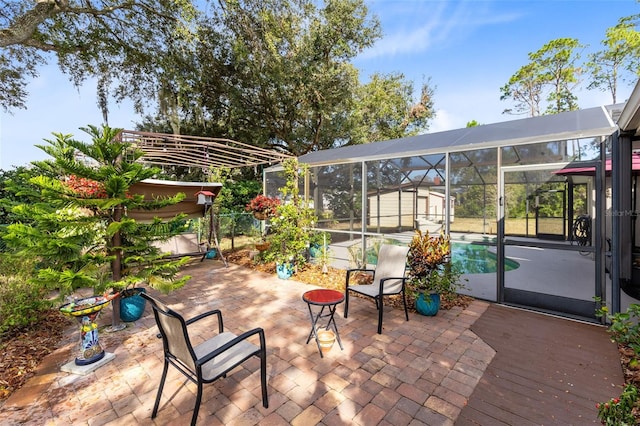 view of patio / terrace with glass enclosure and a storage shed