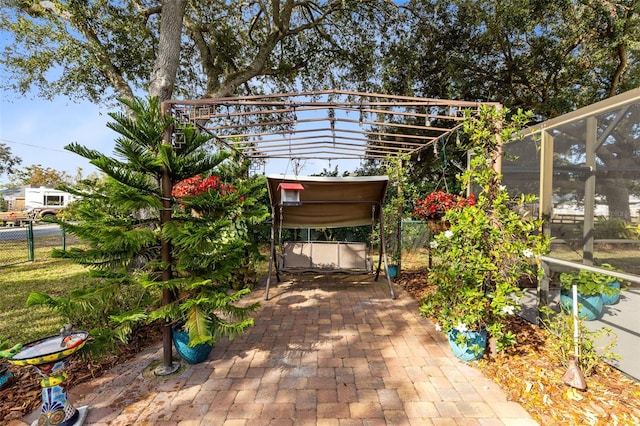 view of patio featuring a lanai