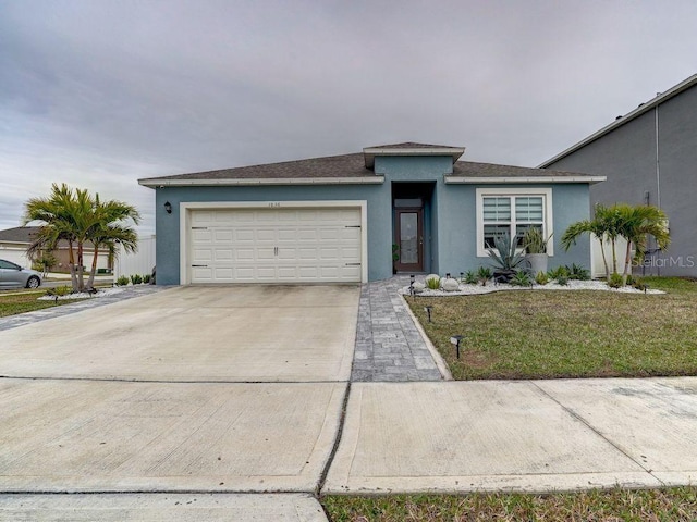 view of front of home featuring a garage and a front lawn