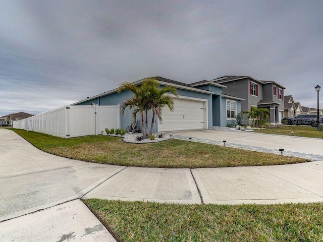 view of front of property with a garage and a front lawn