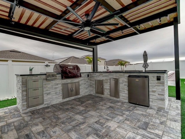 view of patio / terrace with an outdoor kitchen, grilling area, and ceiling fan