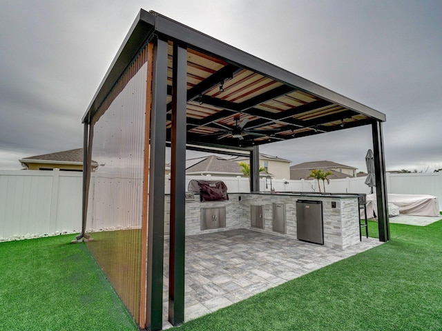 view of patio with area for grilling and ceiling fan