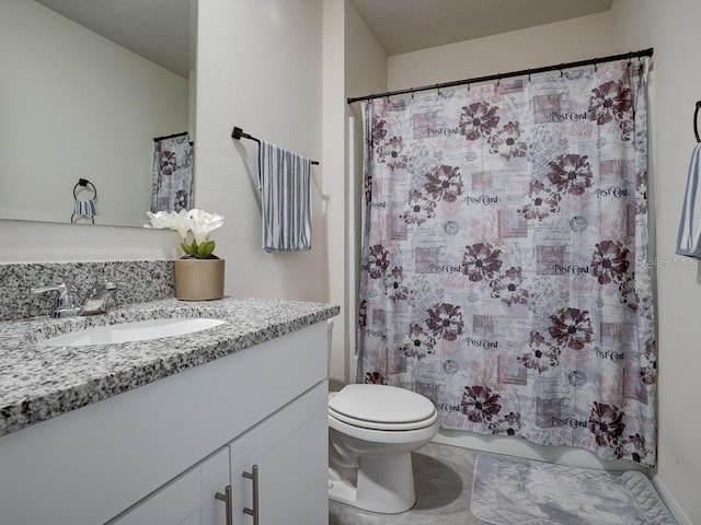 bathroom featuring tile patterned flooring, vanity, and toilet