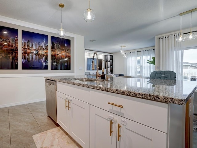 kitchen with hanging light fixtures, a kitchen island with sink, stainless steel dishwasher, and white cabinets