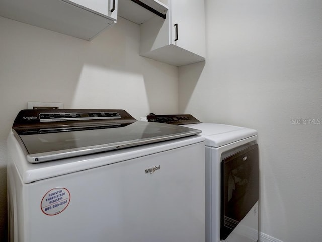 washroom with cabinets and independent washer and dryer