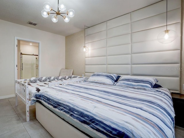 tiled bedroom with connected bathroom and a chandelier