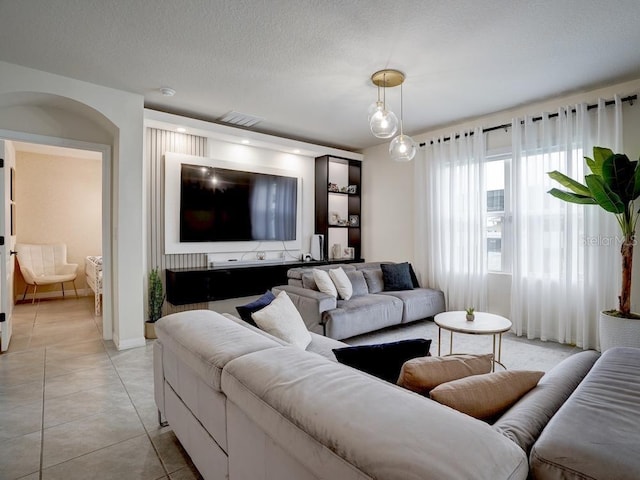 tiled living room with a textured ceiling