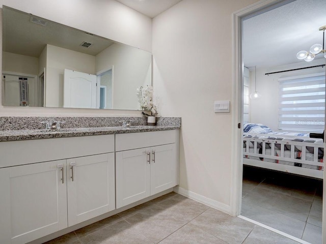 bathroom with tile patterned floors and vanity