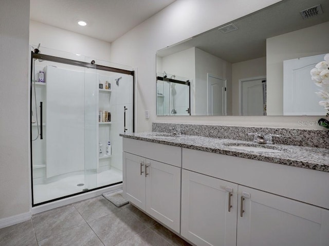 bathroom featuring walk in shower, tile patterned floors, and vanity