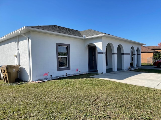 view of front of property featuring a front lawn and a patio area