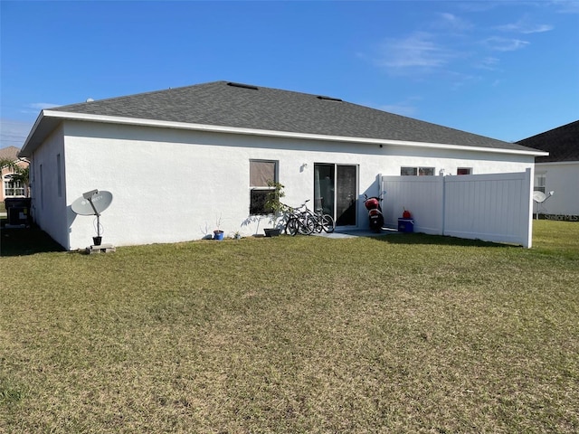 back of house featuring a yard