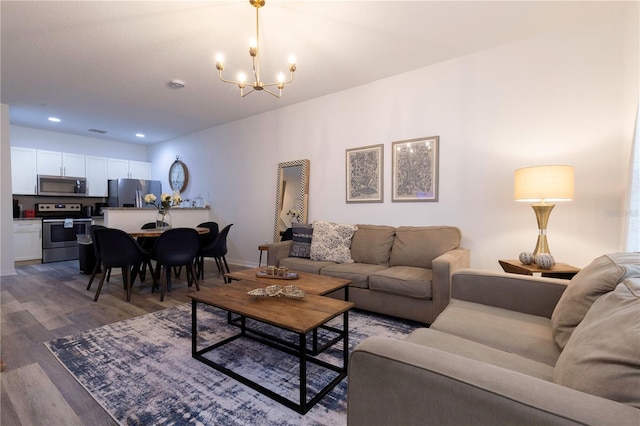 living room with hardwood / wood-style flooring and a chandelier