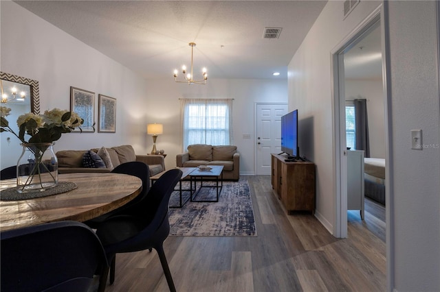 dining space featuring hardwood / wood-style floors and a chandelier