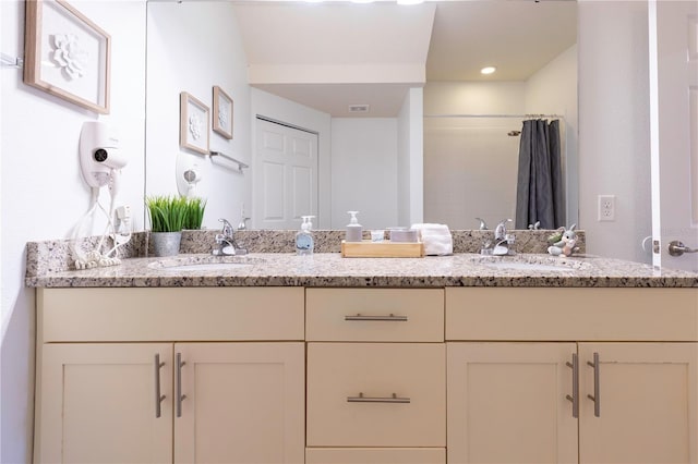 bathroom featuring vanity and curtained shower