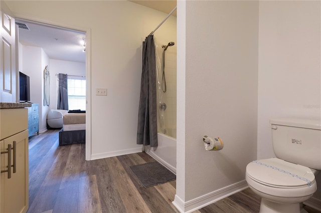 full bathroom featuring vanity, toilet, hardwood / wood-style floors, and shower / bath combo with shower curtain