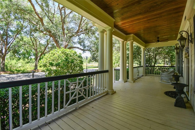 wooden terrace featuring a porch and ceiling fan