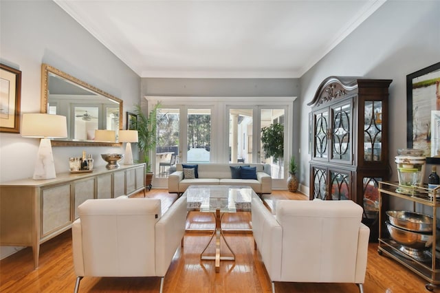 living room with crown molding and light hardwood / wood-style flooring