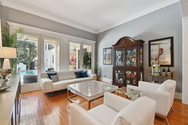 living room with wood-type flooring and ornamental molding