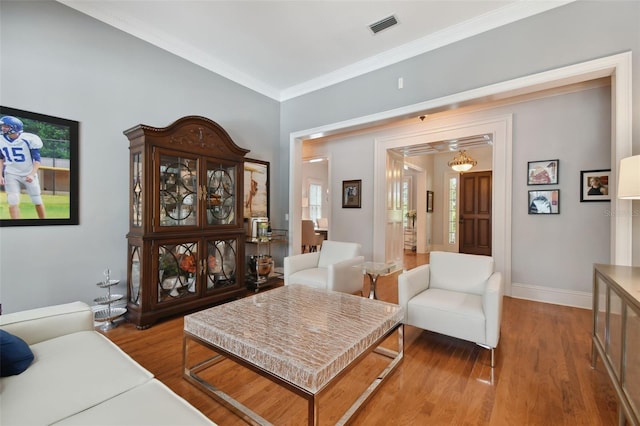 interior space featuring wood-type flooring and crown molding