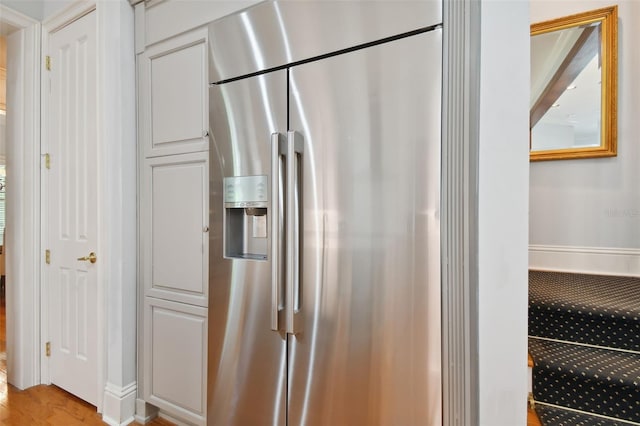 kitchen featuring stainless steel refrigerator with ice dispenser and light hardwood / wood-style floors