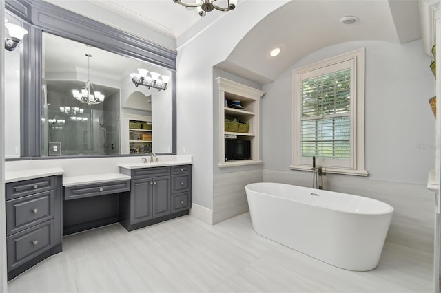 bathroom featuring a washtub, a notable chandelier, vanity, and ornamental molding