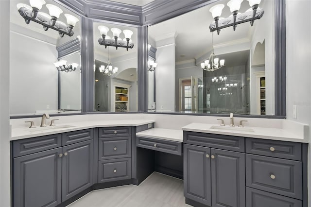 bathroom featuring an inviting chandelier, ornamental molding, walk in shower, and vanity